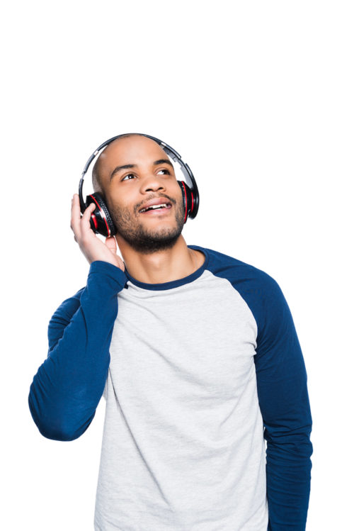 pensive young african american man listening music in headphones and looking away isolated on white